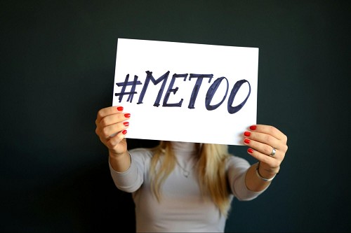 Woman holding a sign with the word 